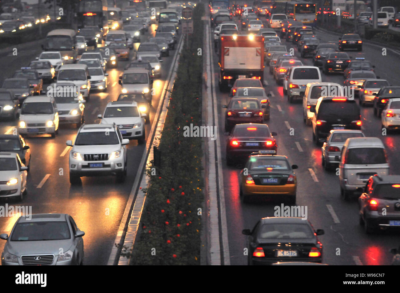 Vehicles move slowly in a traffic jam during the rush hour on a road in