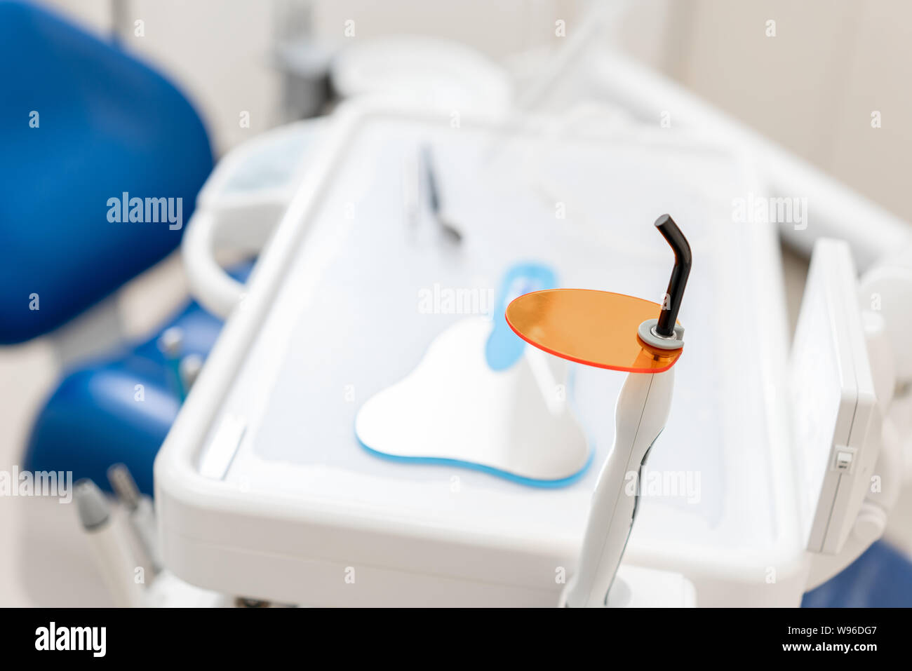 Dental polymerization lamp with UV light and laser. Stomatological instrument in the dentist clinic. Medicine, health, stomatology concept. Stock Photo