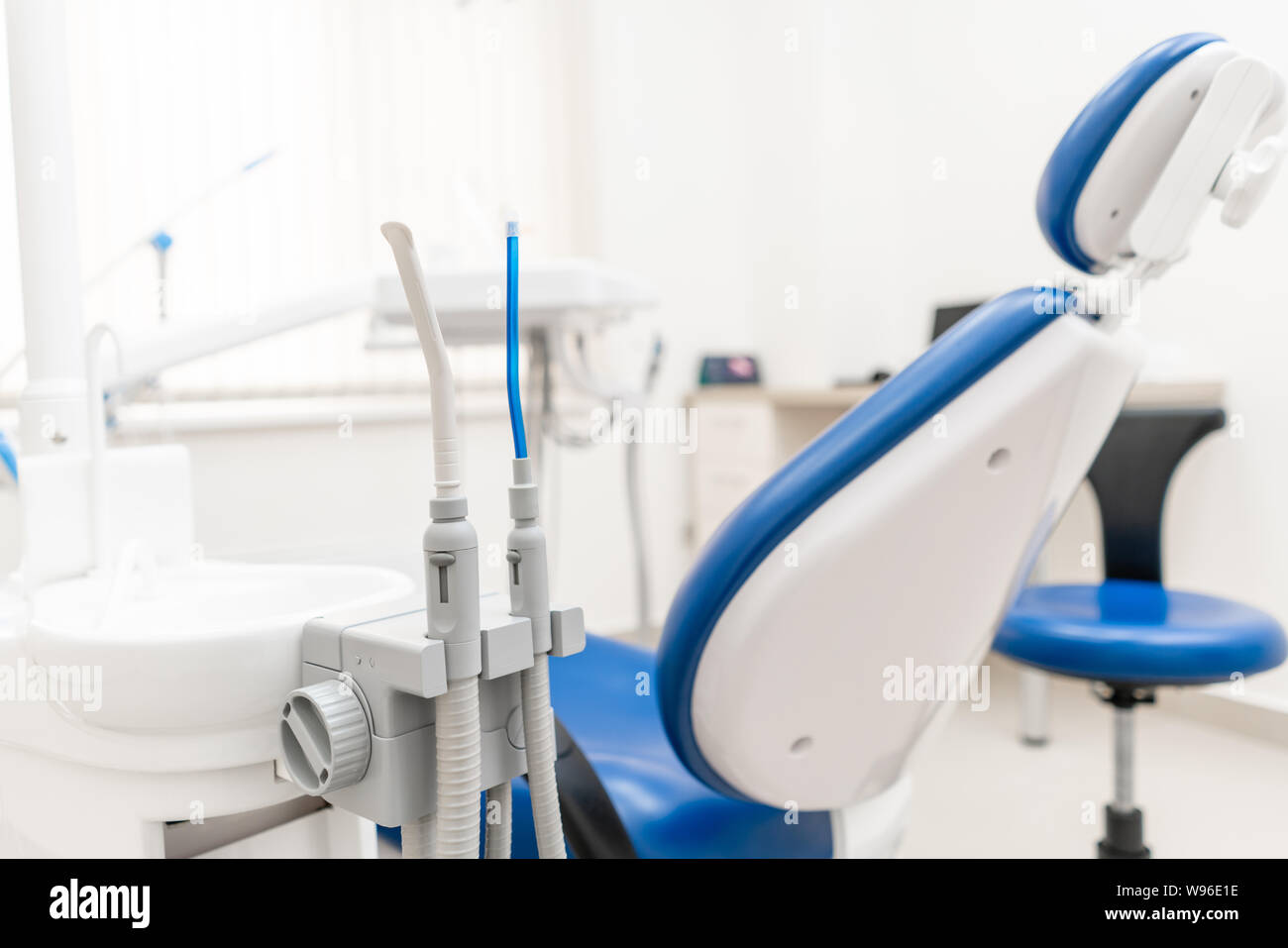 Closeup dentist saliva ejector. Dental work in clinic. Operation