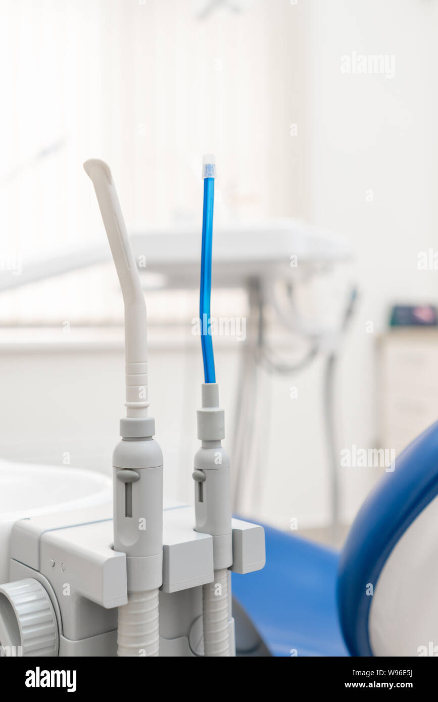 Closeup dentist saliva ejector. Dental work in clinic. Operation
