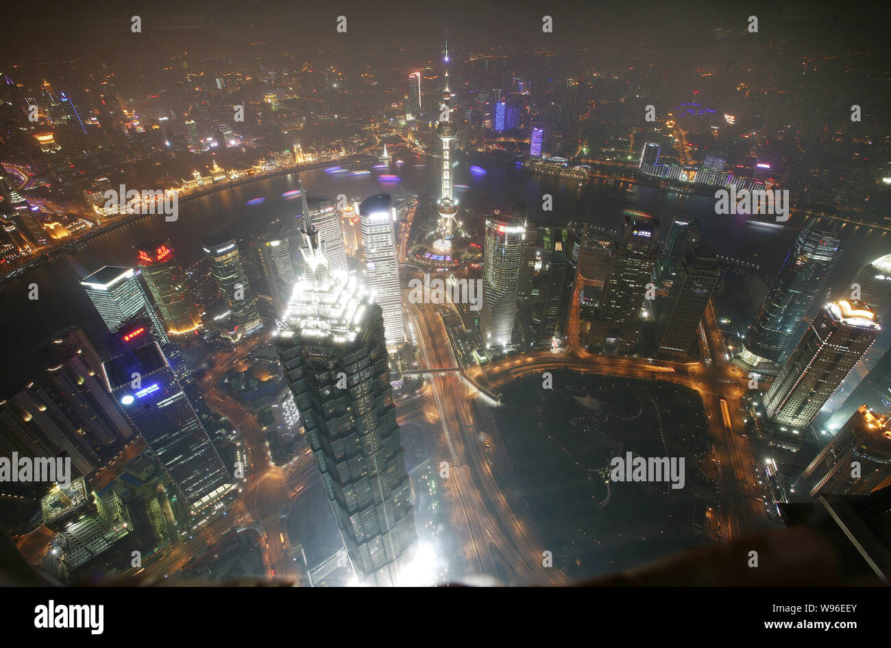 Aerial night view of Jinmao Tower, front, and other skyscrapers and high-rise commercial buildings before the lights are turned off to mark the Earth Stock Photo