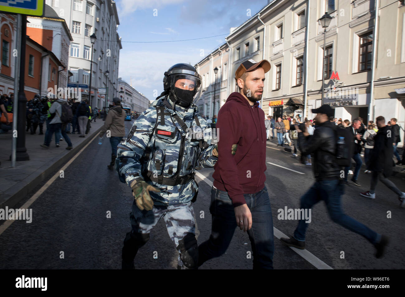 Moscow, August 10 2019. Riot police officers detain a participant of an ...