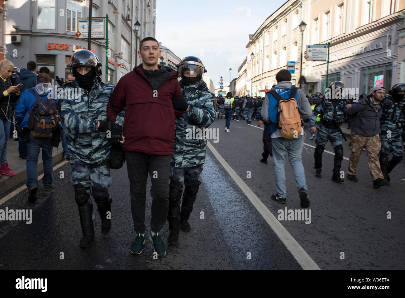 Moscow, August 10 2019. Riot police officers detain a participant of an ...