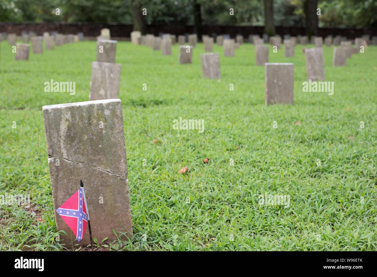 A small Confederate flag on a grave at the Confederate Cemetery in Fayetteville, Arkansas, USA. Stock Photo