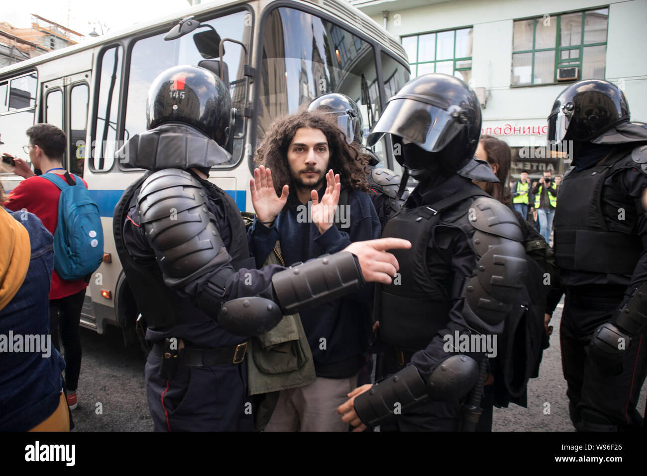 Moscow, August 10 2019. Riot police officers detain a participant of an ...