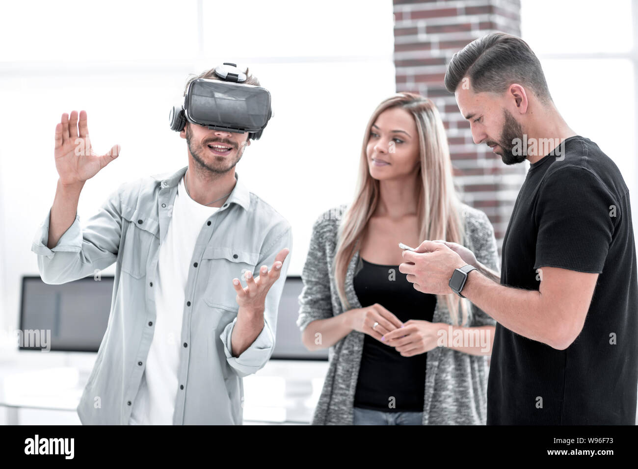 Positive colleagues testing virtual reality device Stock Photo