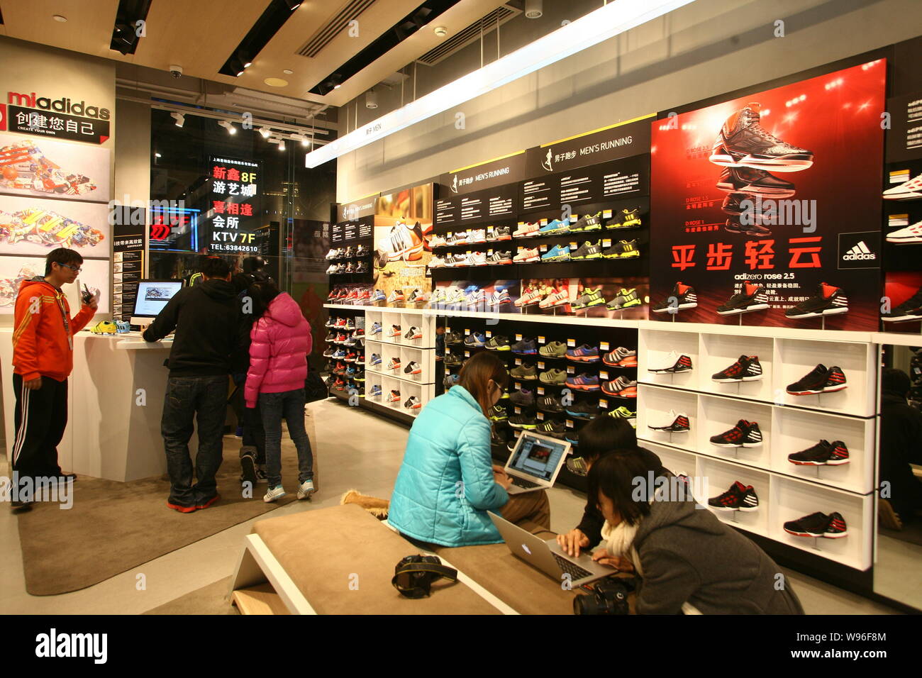 File--Staff and customers are seen in a newly opened Adidas store in  Shanghai, China, 11 January 2012. Adidas AG will aim at niches such as high  f Stock Photo - Alamy