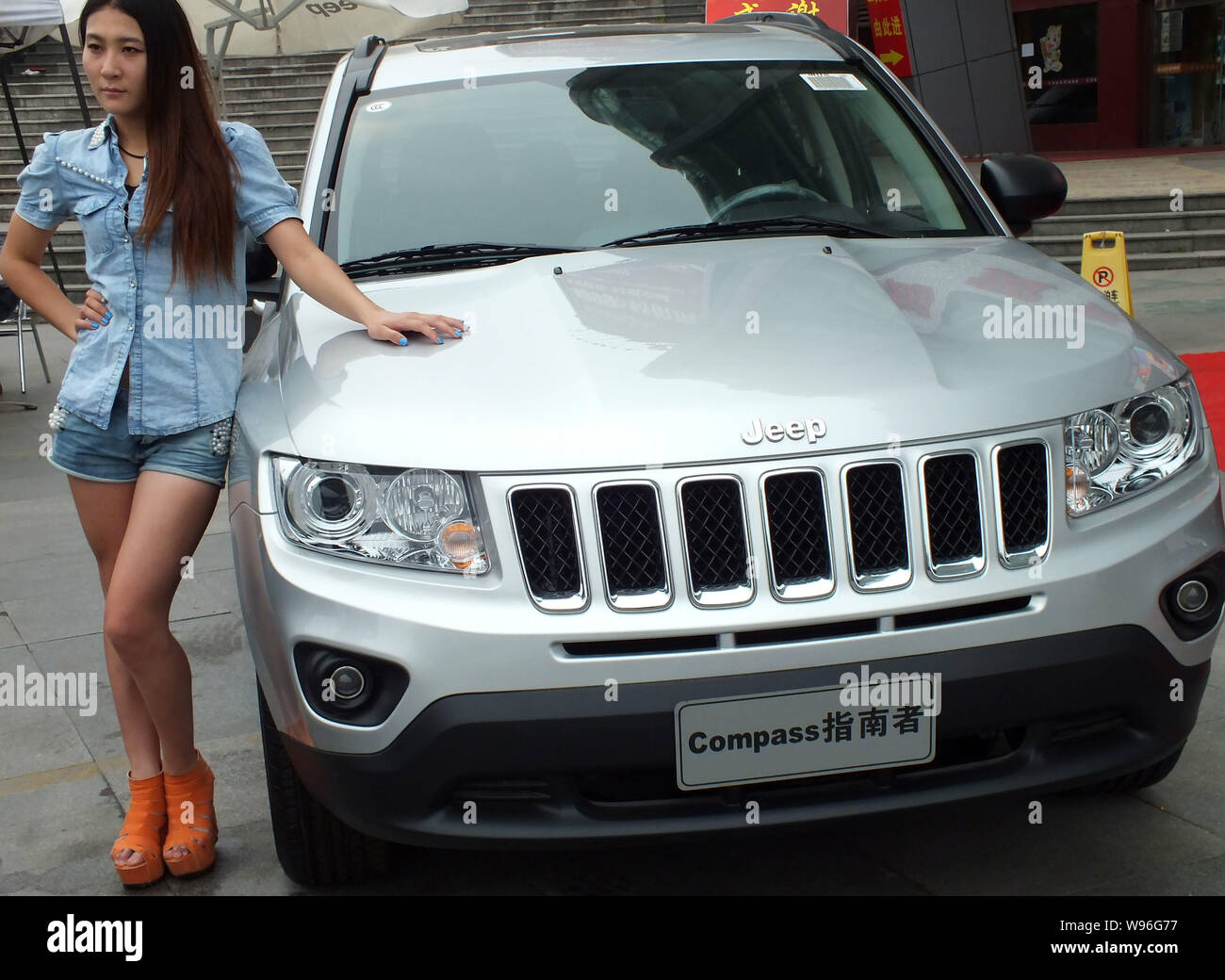 --File--A model poses beside a Jeep SUV during an exhibition in Yichang, central Chinas Hubei province, 6 May 2012.   Jeep sales rose 63 percent last Stock Photo