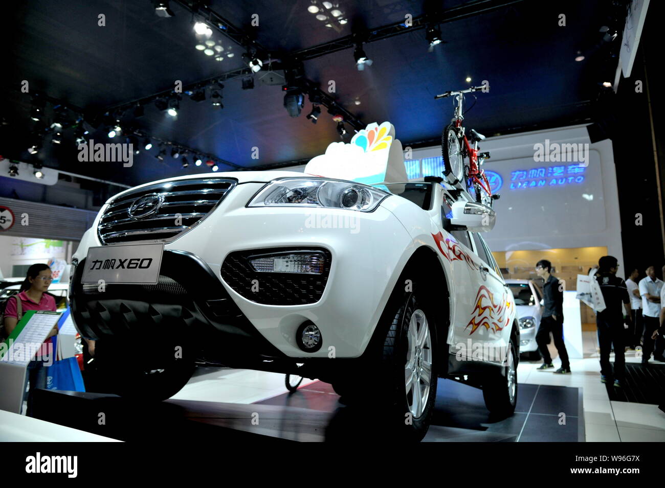 --FILE--Visitors look at a Lifan X60 and other Lifan cars during an ...