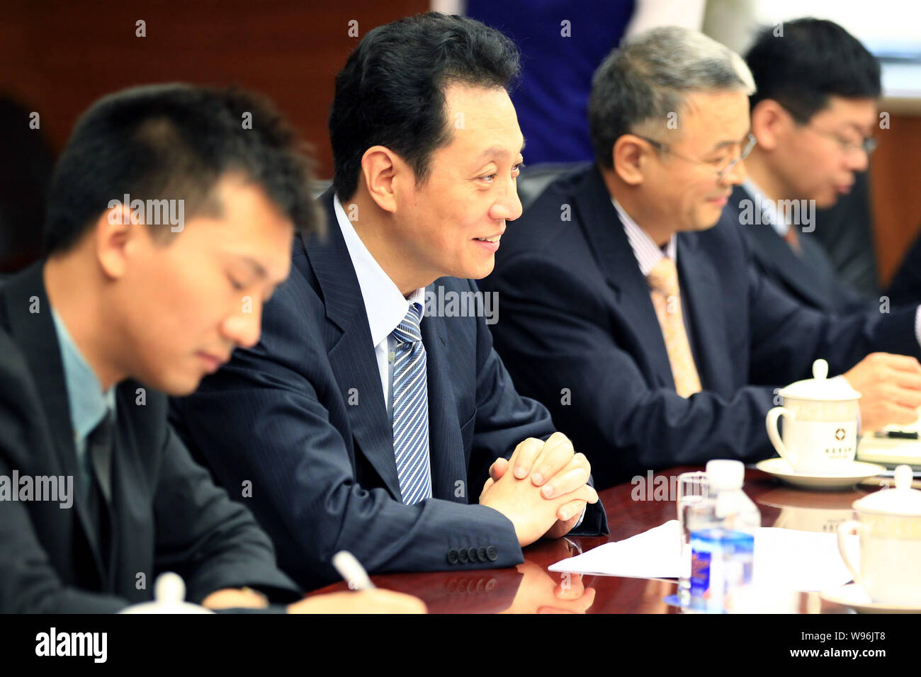 Wang Chao, second left, Vice Minister of Commerce of China, listens during a meeting with Daniel J. Brutto, President of UPS International, in Beijing Stock Photo