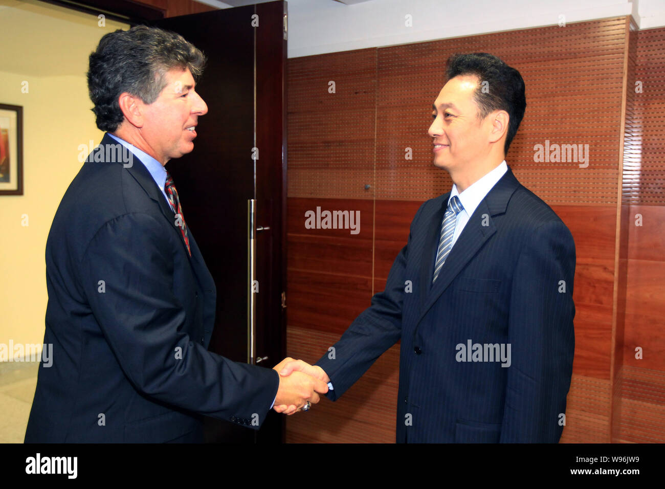 Daniel J. Brutto, left, President of UPS International, shakes hands with Wang Chao, Vice Minister of Commerce of China, before a meeting in Beijing, Stock Photo