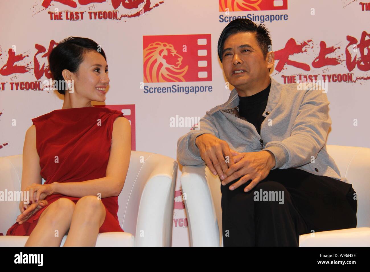 Cast members, Chow Yun-fat, right, and Yolanda Yuan, highlight a press conference for their latest movie, The Last Tycoon, in Singapore, 4 December 20 Stock Photo