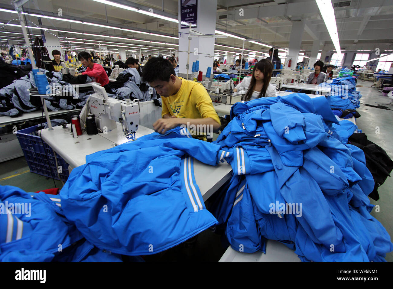 Workers make sportswear at a garment factory in Jinjiang, south Chinas  Fujian province, 28 March 2012. Is Chinas manufacturing sector rebounding  str Stock Photo - Alamy