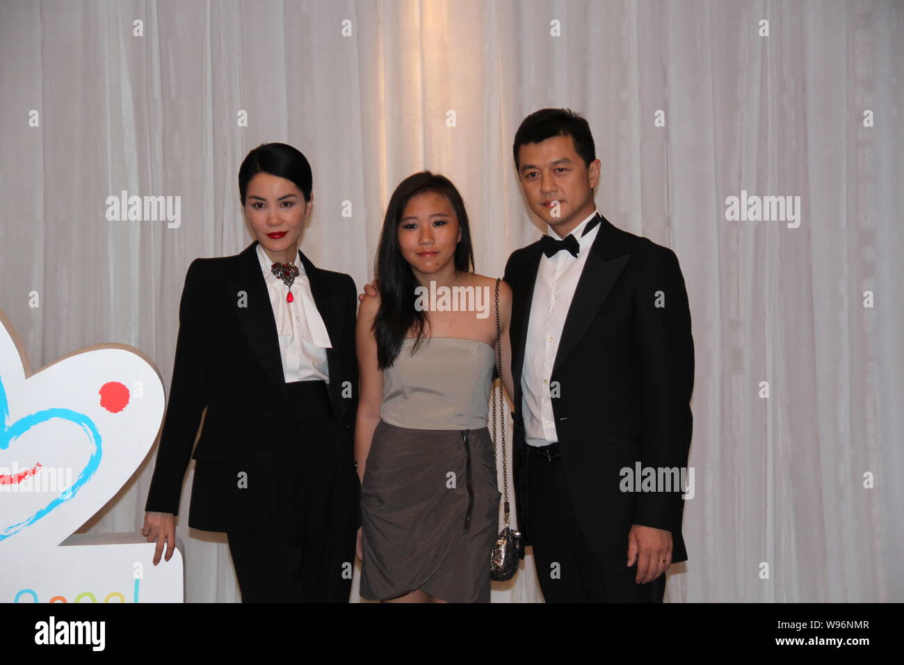 Hong Kong singer Faye Wong, her daughter Tong Tong (Dou Jingtong) and  husband, Chinese actor Li Yapeng pose during a charity event in Beijing,  China Stock Photo - Alamy