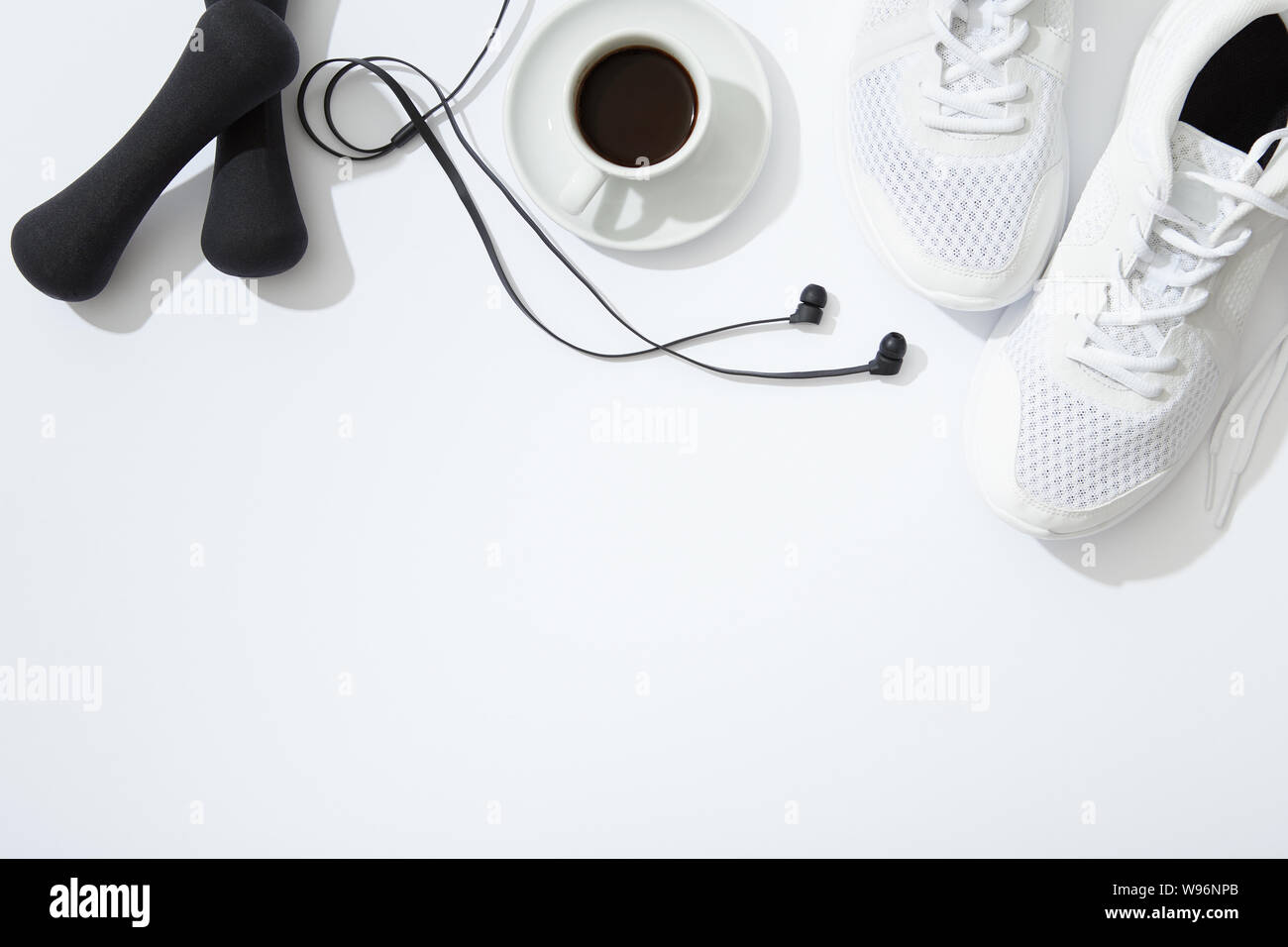 Sport flat lay with gym equipment accessories and coffee on white background Stock Photo