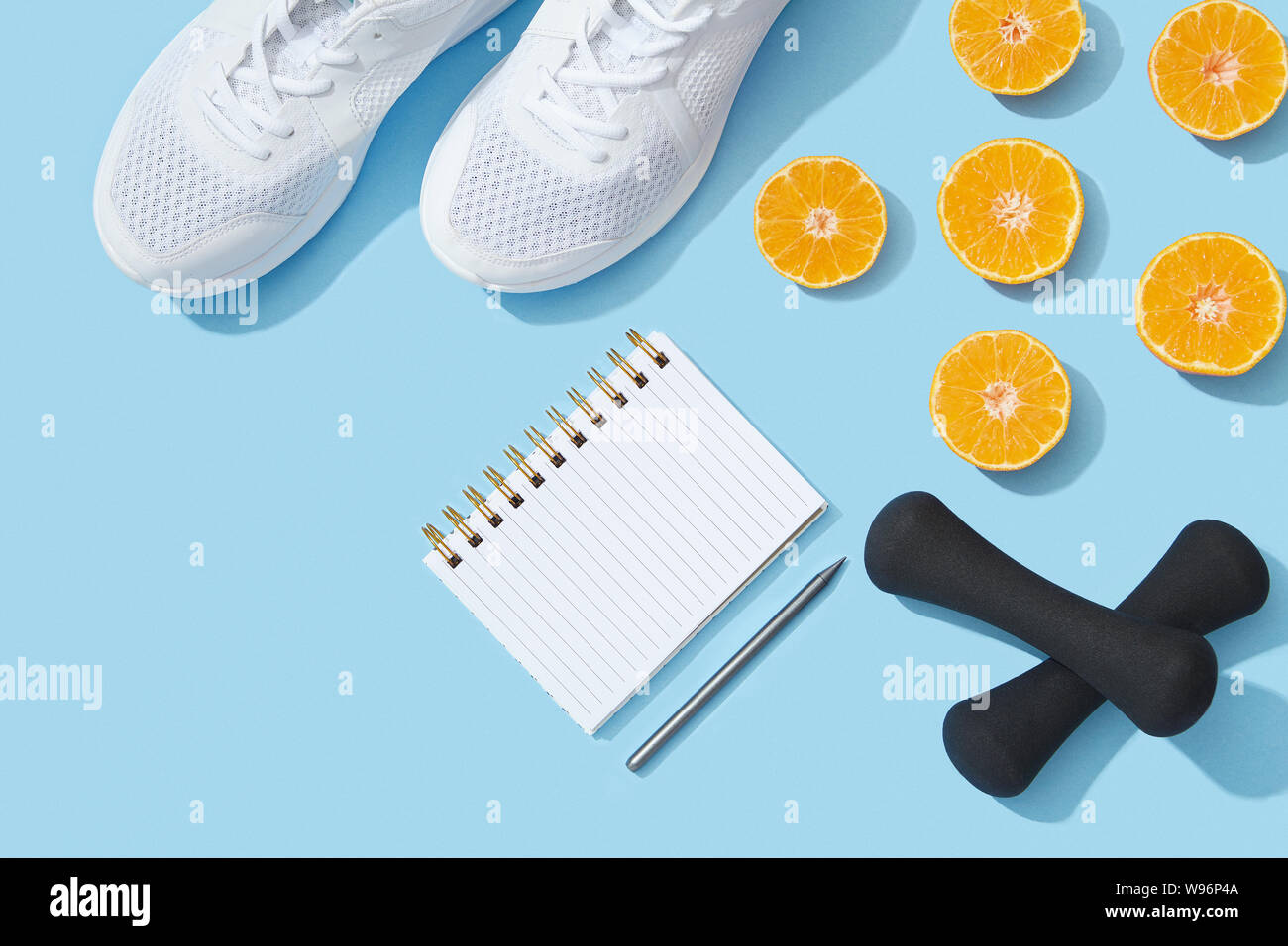 Sport flat lay with gym equipment and accessories on blue background Stock Photo