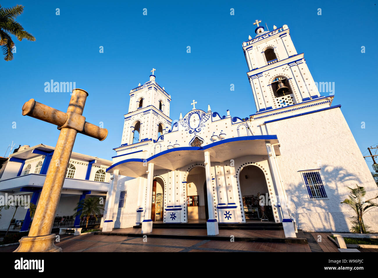 The Basilica of Our Lady of Mount Carmel Catholic Church in Catemaco, Veracruz, Mexico. The town is built along a tropical freshwater lake at the center of the Sierra de Los Tuxtlas mountains, is a popular tourist destination and known for free ranging monkeys, the rainforest backdrop and Mexican witches known as Brujos. Stock Photo