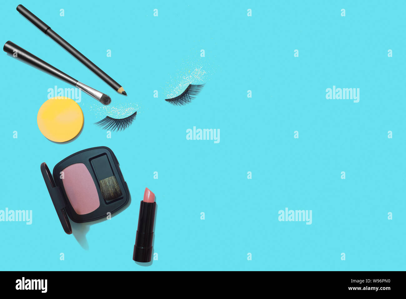 Woman makeup products on blue background, saturated cosmetics flat lay Stock Photo
