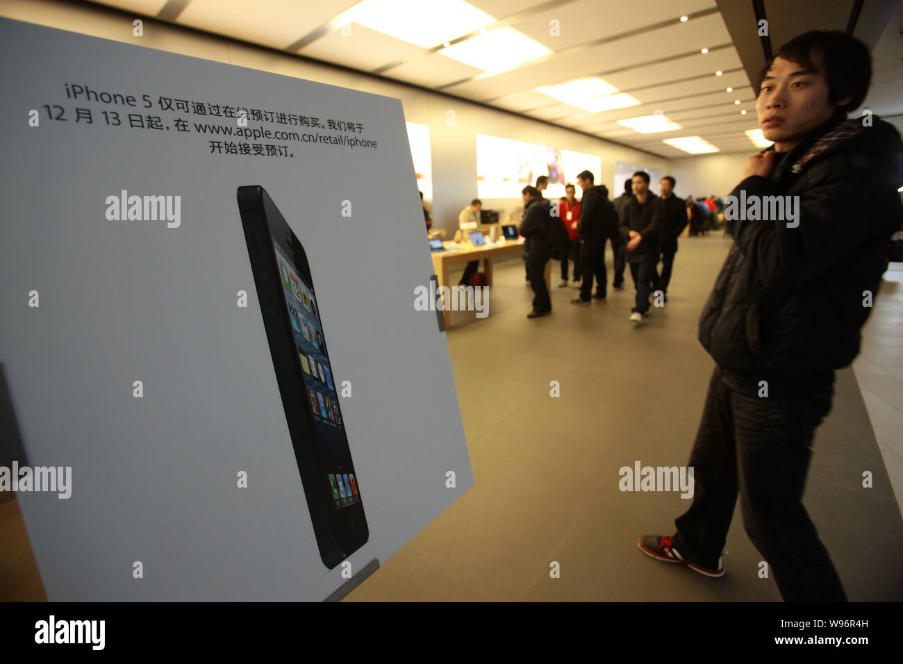 Customers Walk Past An Advertising Poster Of The Iphone 5 Smartphone At An Apple Store In Shanghai China 13 December 12 The China Release Of It Stock Photo Alamy