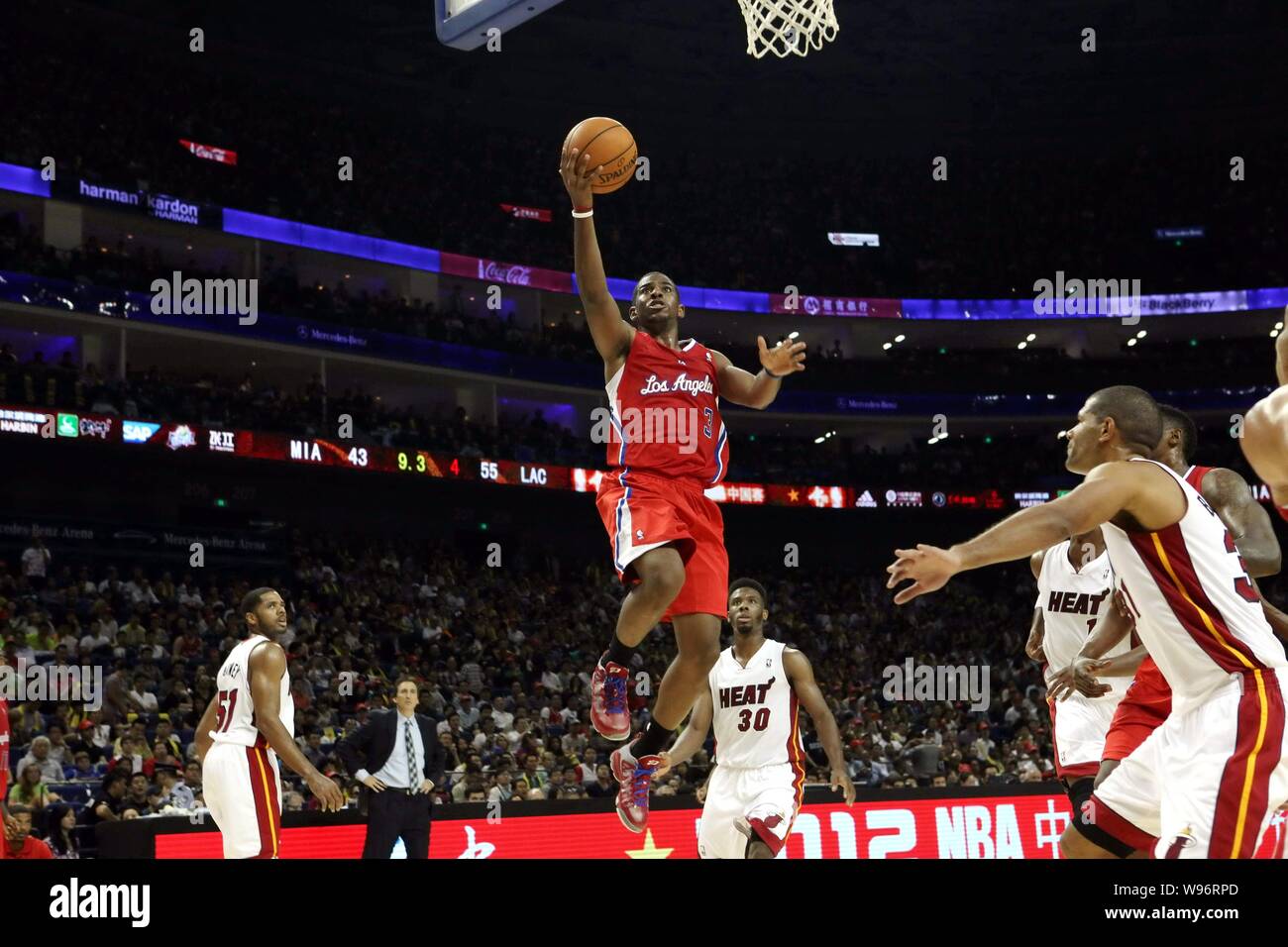 Chris Paul of the Los Angeles Clippers, top, jumps to score against the Miami Heat during their second match of their NBA China Games in Shanghai, Chi Stock Photo