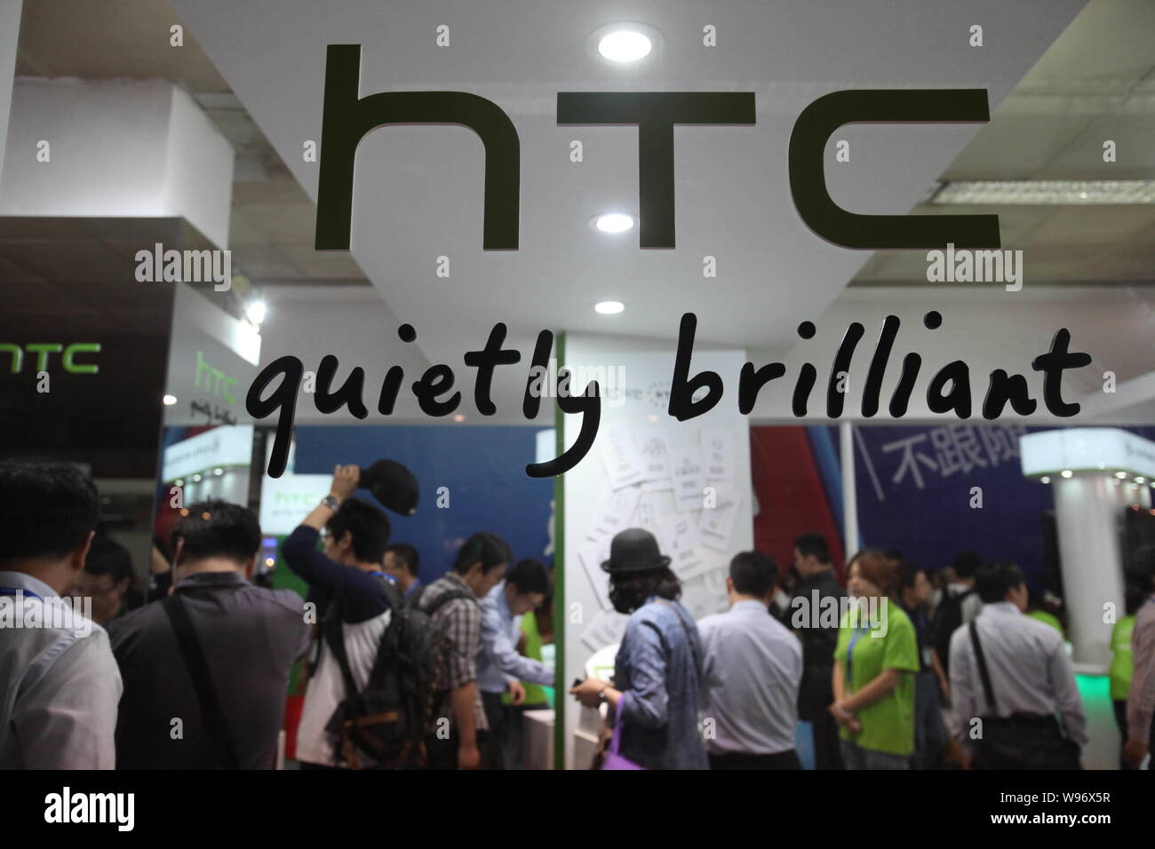 --File--Visitors are seen at the stand of HTC during an exhibition in Beijing, China, 27 September 2011.   Packed with a number of popular Chinese app Stock Photo