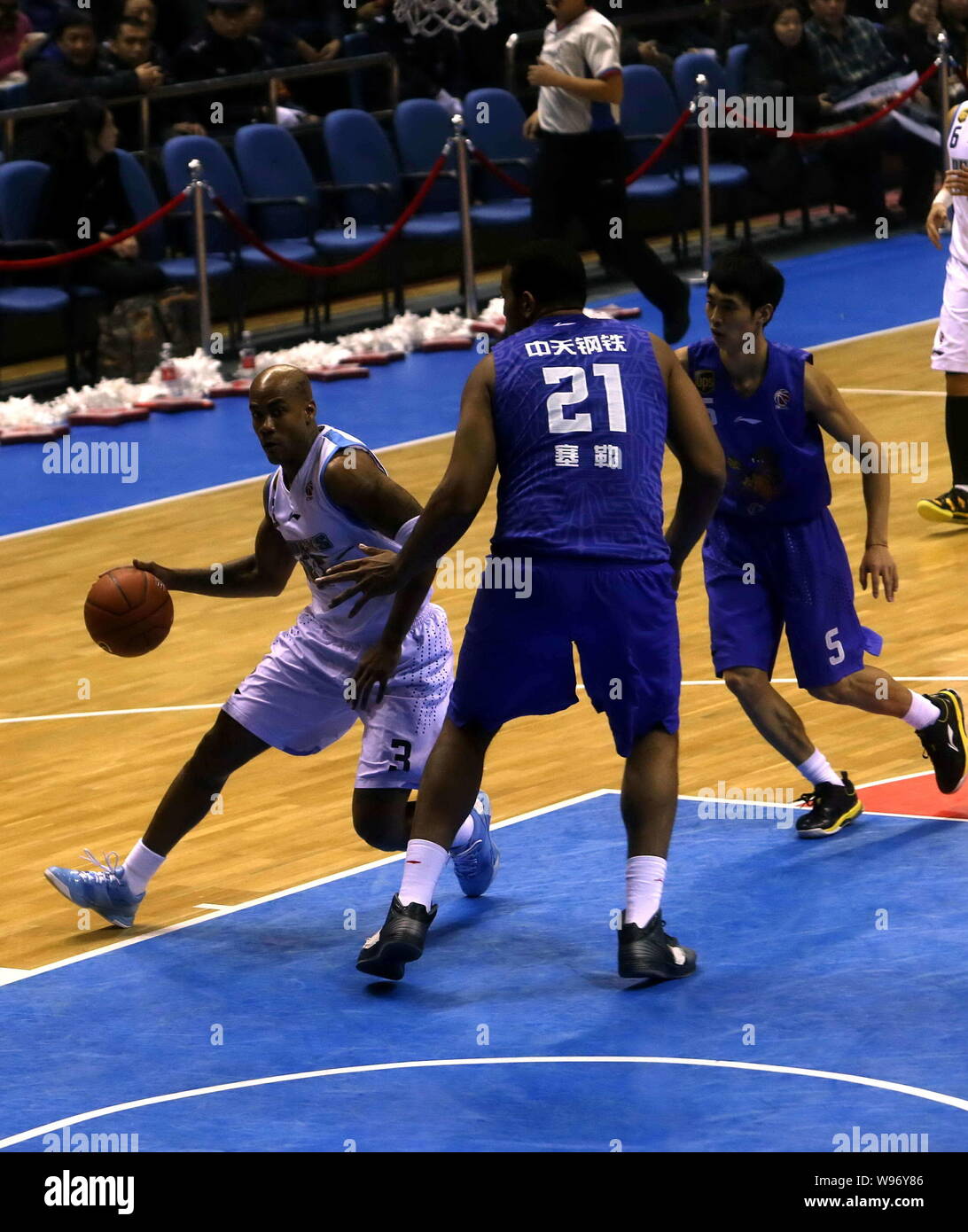Stephon Marbury of the Beijing Ducks, left, challenges Garret Siler of the Jiangsu Dragons in their 11th round match during the 2012/2013 CBA season i Stock Photo