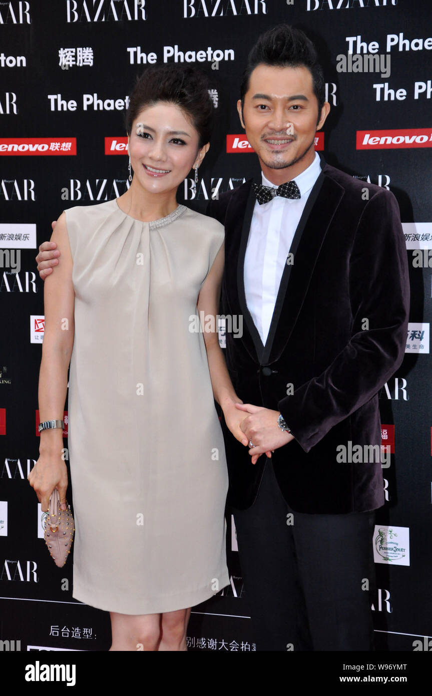Chinese actor Sha Yi, right, and his actress wife Hu Ke pose on the red carpet as they arrive for the 2012 BAZAAR Stars Charity Night in Beijing, Chin Stock Photo