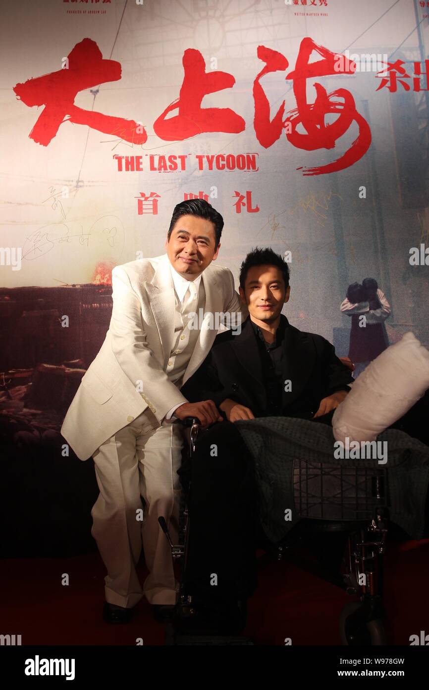 Hong Kong actor Chow Yun-fat, left, poses with Chinese actor Huang Xiaoming whose right leg and foot were injured during the premiere of the movie, Th Stock Photo