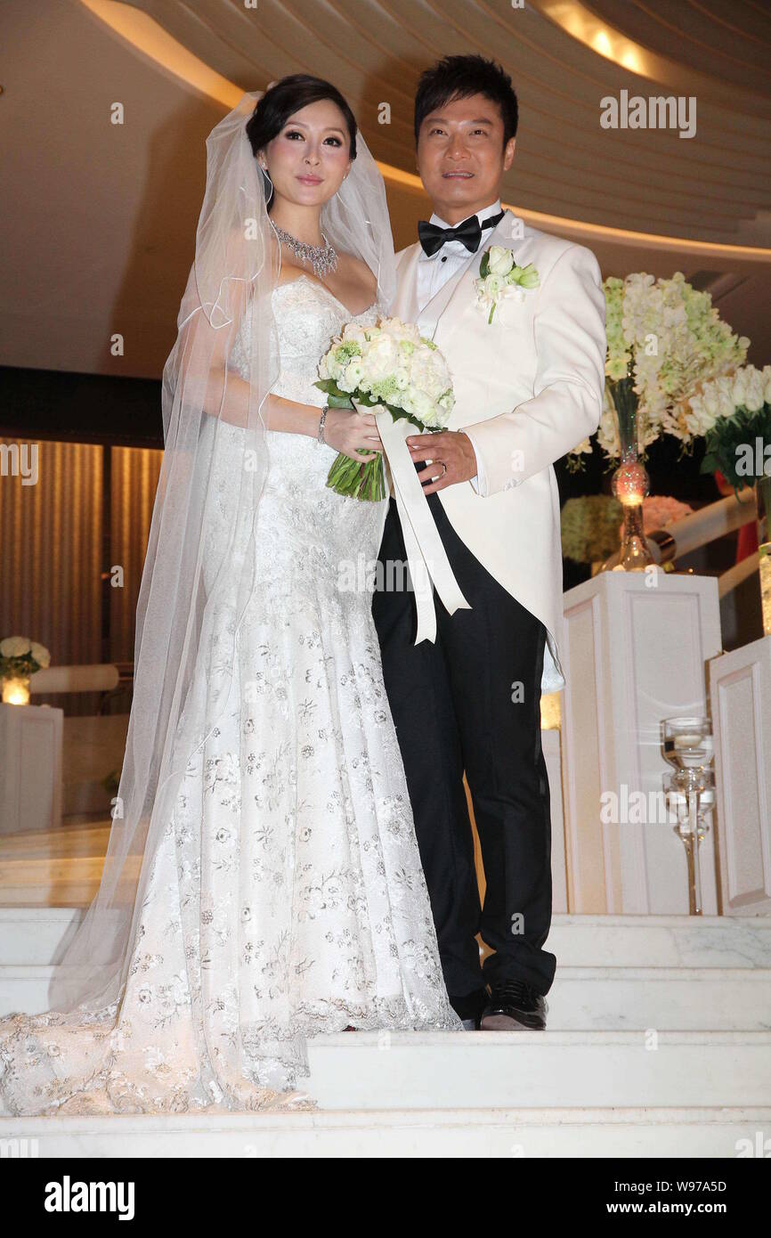 Hong Kong actor Chin Ka Lok, right, poses with his pregnant actress