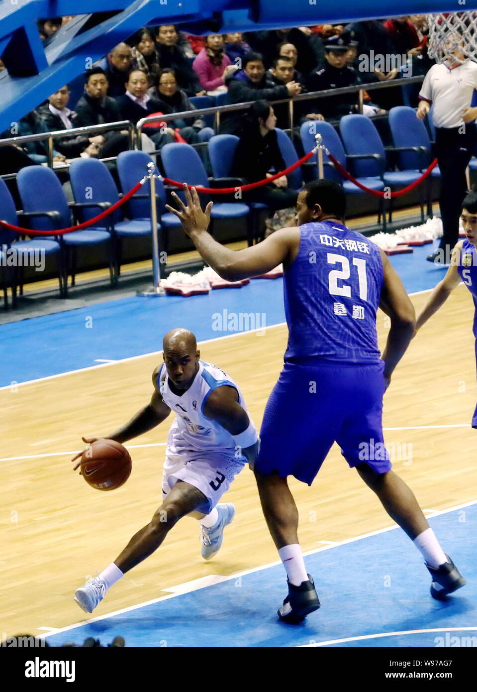 Stephon Marbury of the Beijing Ducks, left, challenges Garret Siler of the Jiangsu Dragons in their 11th round match during the 2012/2013 CBA season i Stock Photo