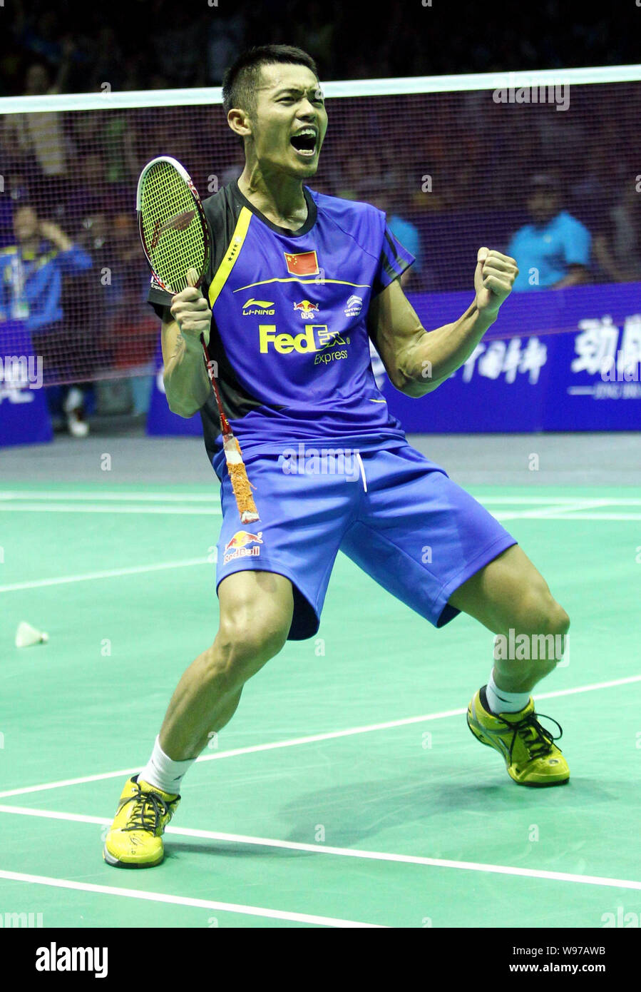Lin Dan of China celebrates after defeating Lee Hyun-Il of South Korea during the final match of the Thomas Cup world badminton team championships in Stock Photo