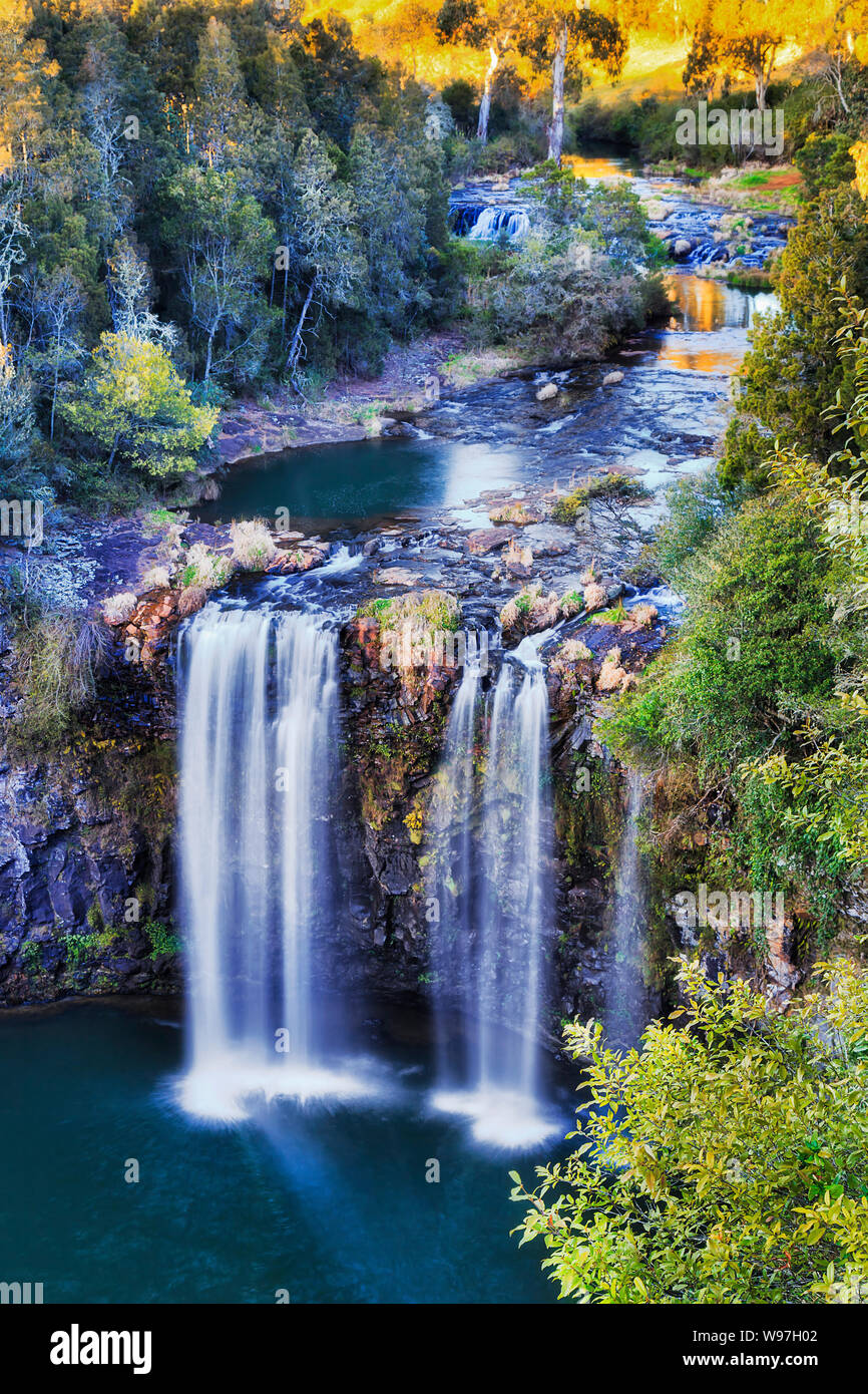 Dangar falls cascade of waterfalls flowing down through lava basalt plateau in Dorrigo National park of Australia seen from elevated lookout at sunris Stock Photo