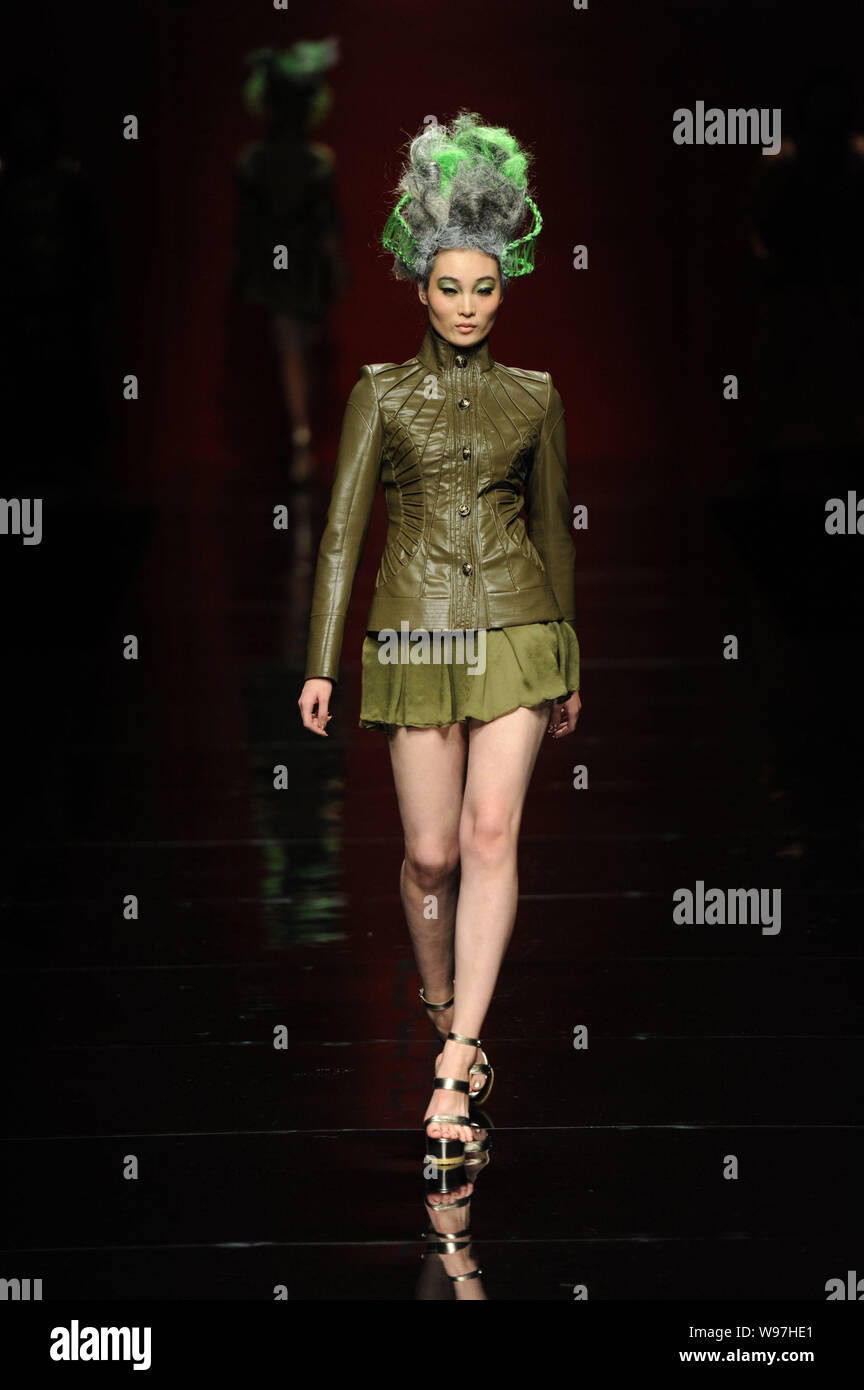 A model displays a new creation in the She Guang Hu fashion show during ...