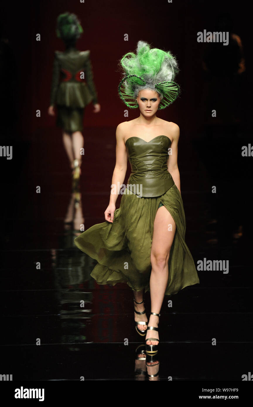 A model displays a new creation in the She Guang Hu fashion show during ...