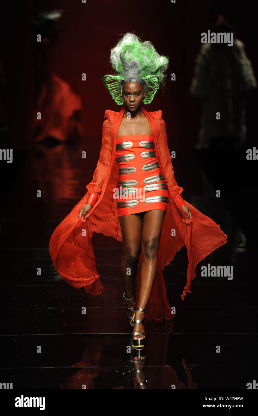 A model displays a new creation in the She Guang Hu fashion show during ...
