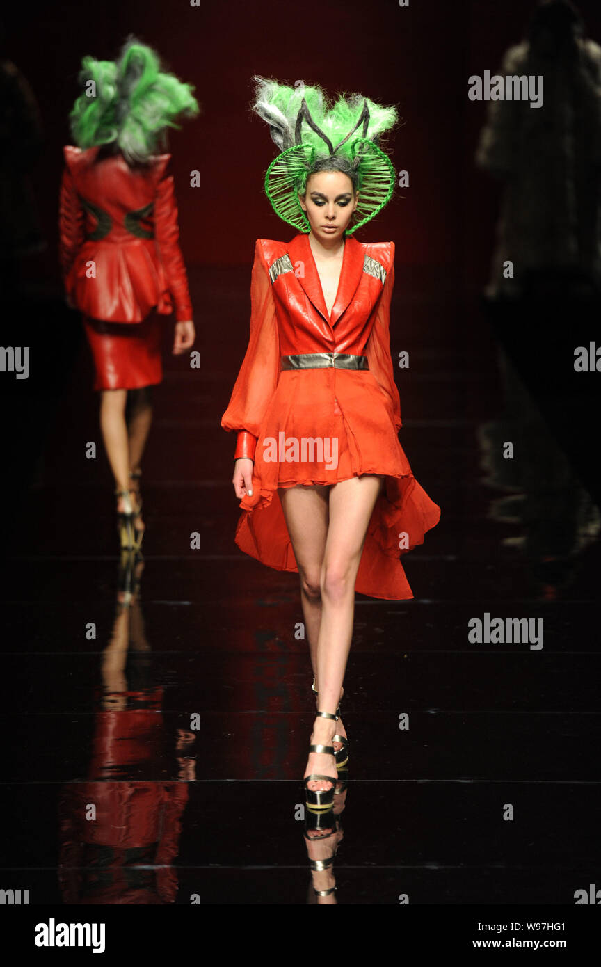 A model displays a new creation in the She Guang Hu fashion show during