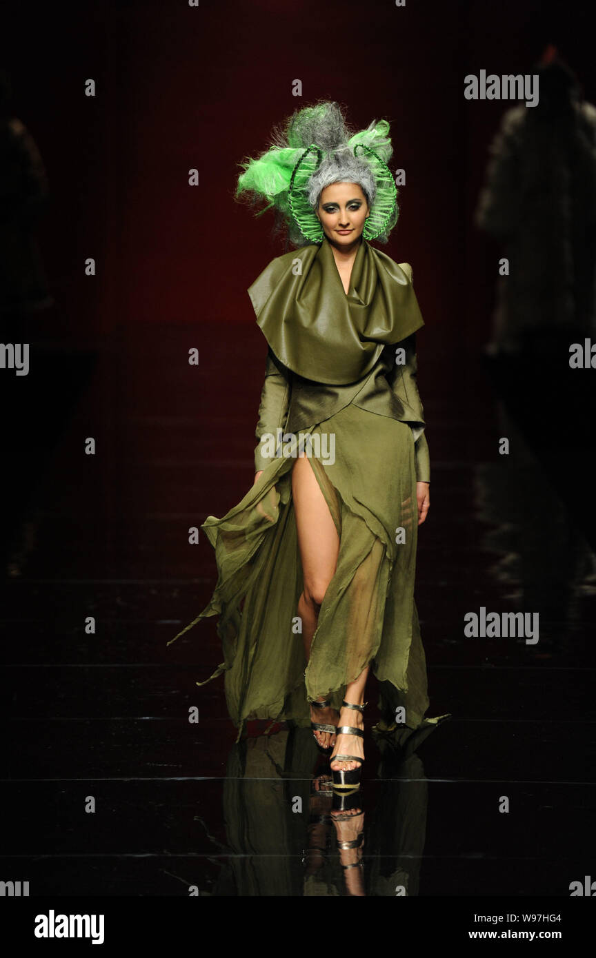 A model displays a new creation in the She Guang Hu fashion show during ...
