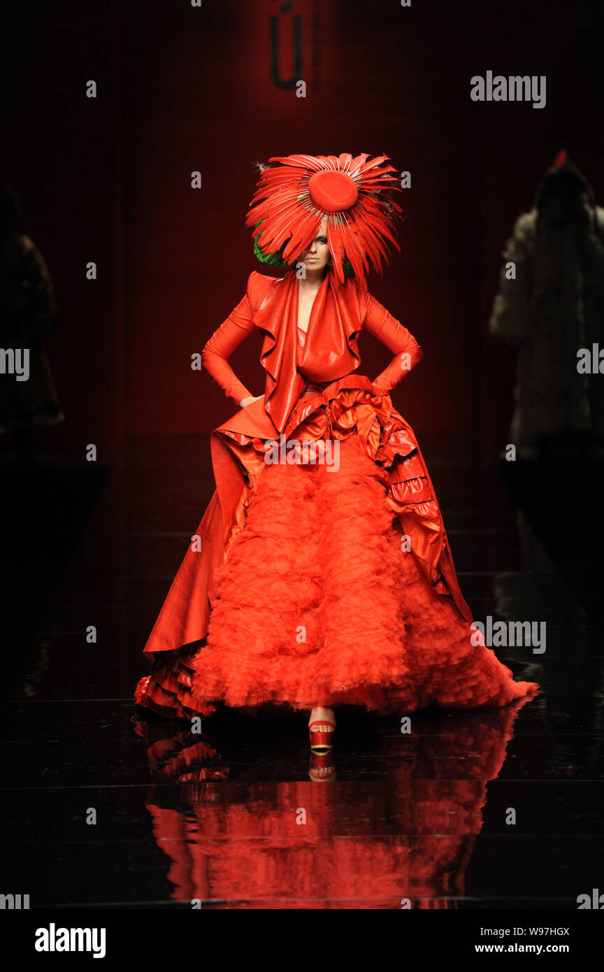 A model displays a new creation in the She Guang Hu fashion show during