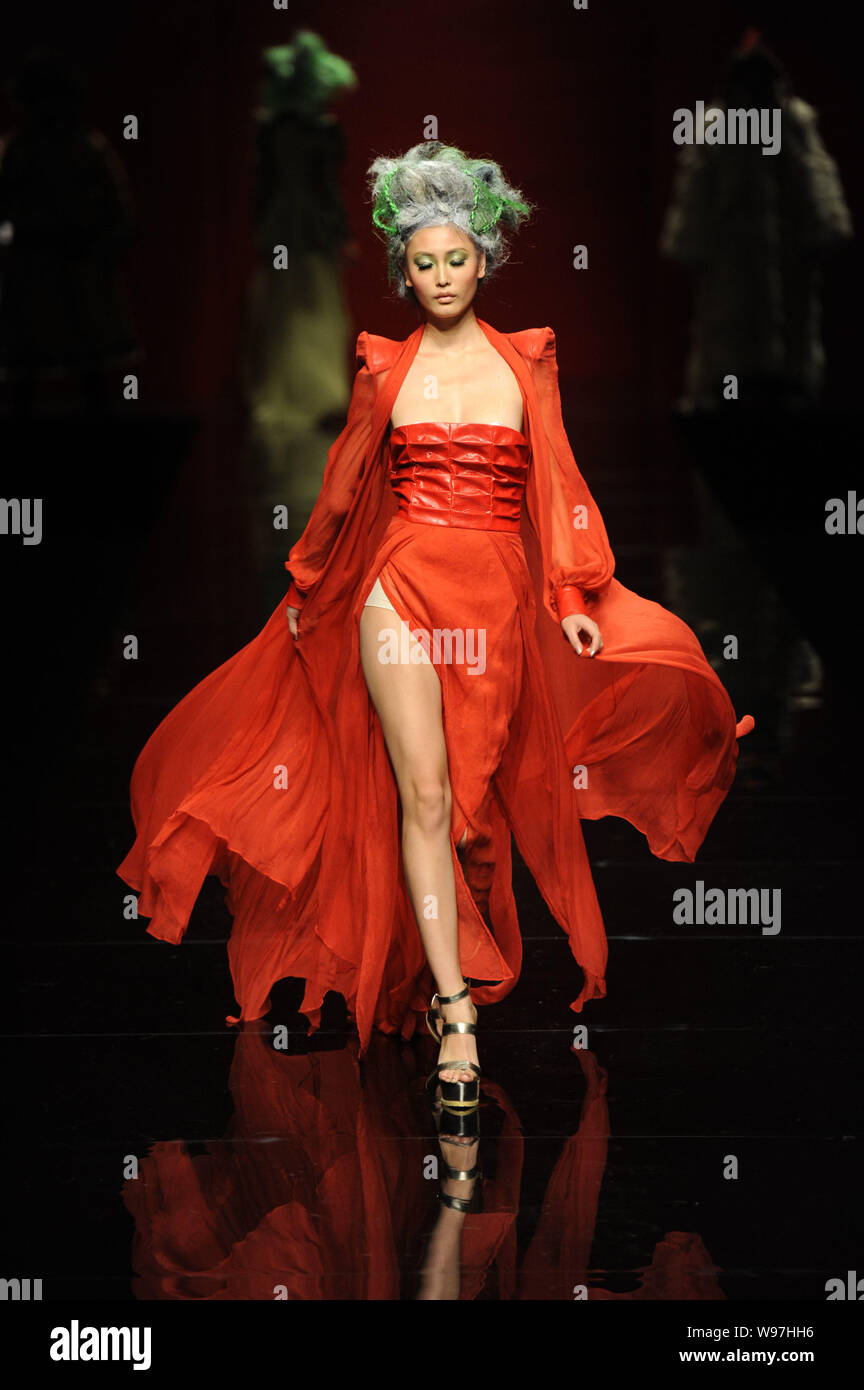 A model displays a new creation in the She Guang Hu fashion show during ...