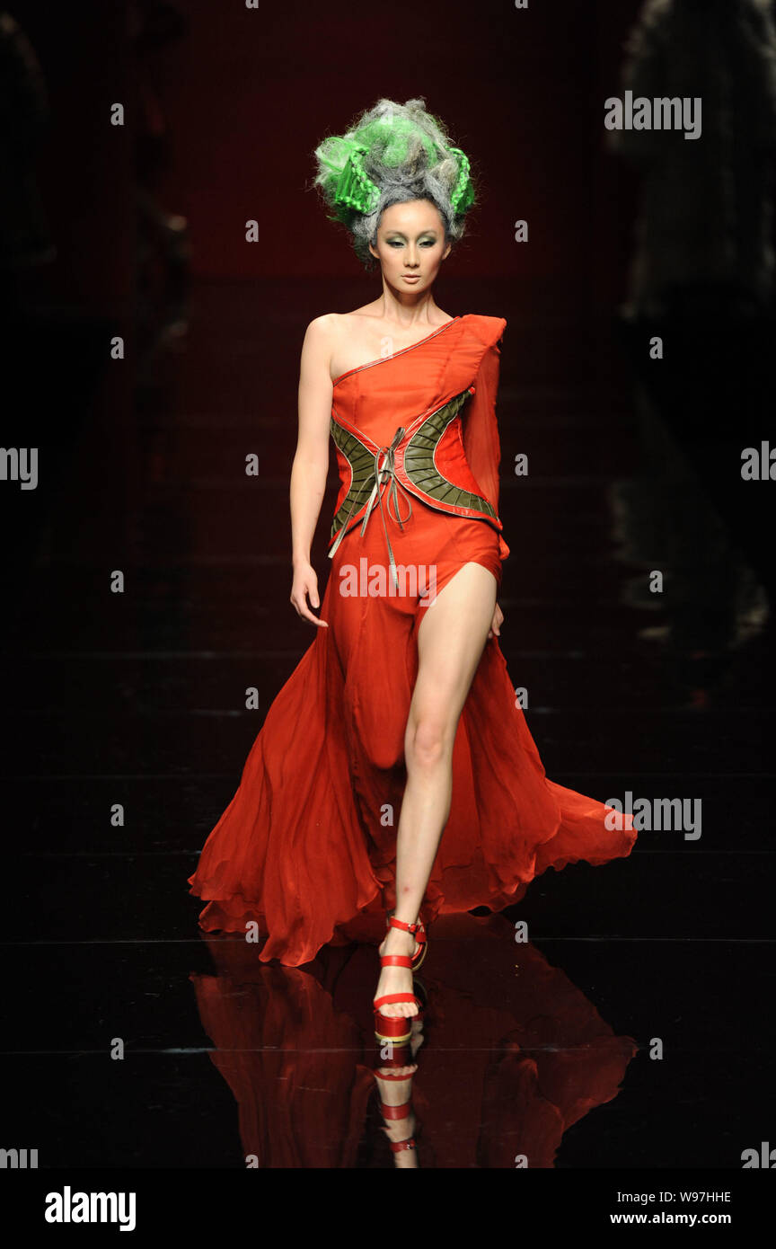 A model displays a new creation in the She Guang Hu fashion show during ...