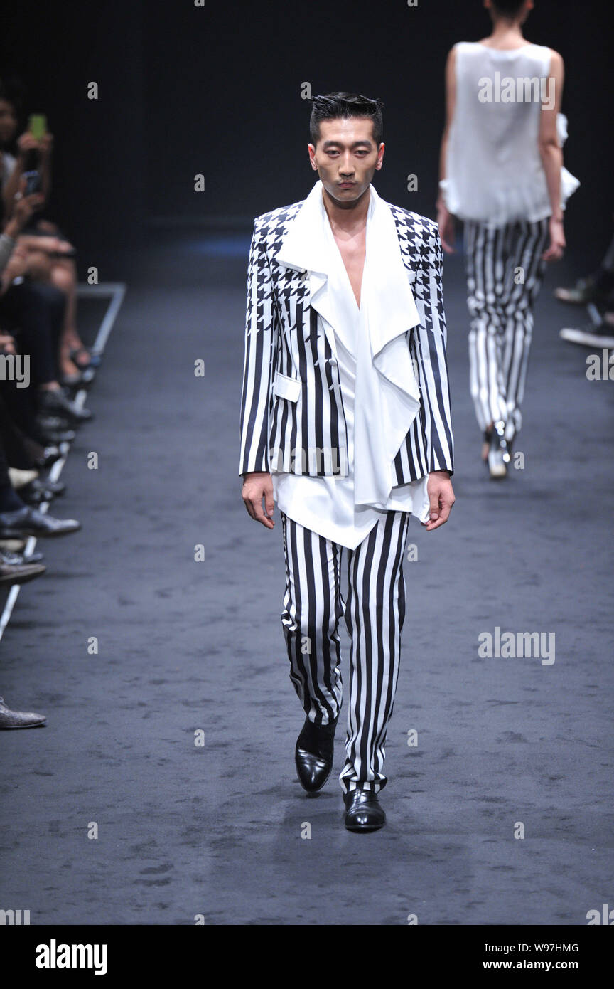 A model displays a new creation by designer Wang Peiyi in his fashion ...