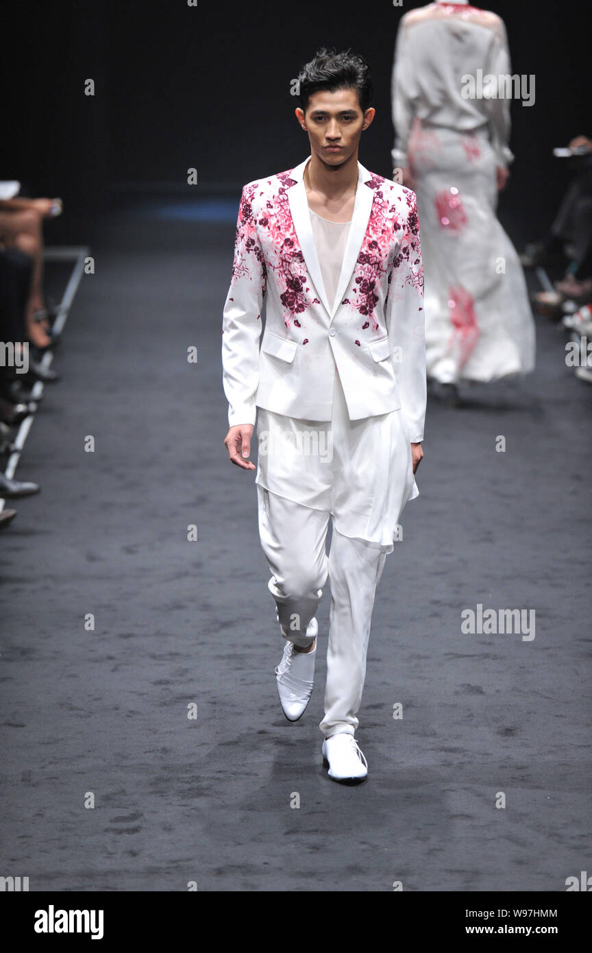 A model displays a new creation by designer Wang Peiyi in his fashion ...