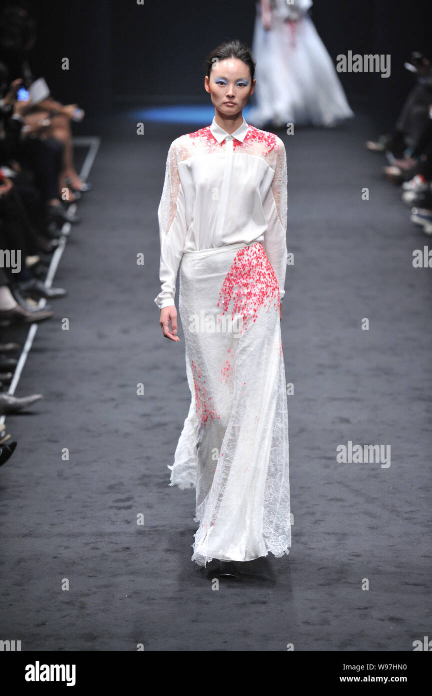 A model displays a new creation by designer Wang Peiyi in his fashion ...