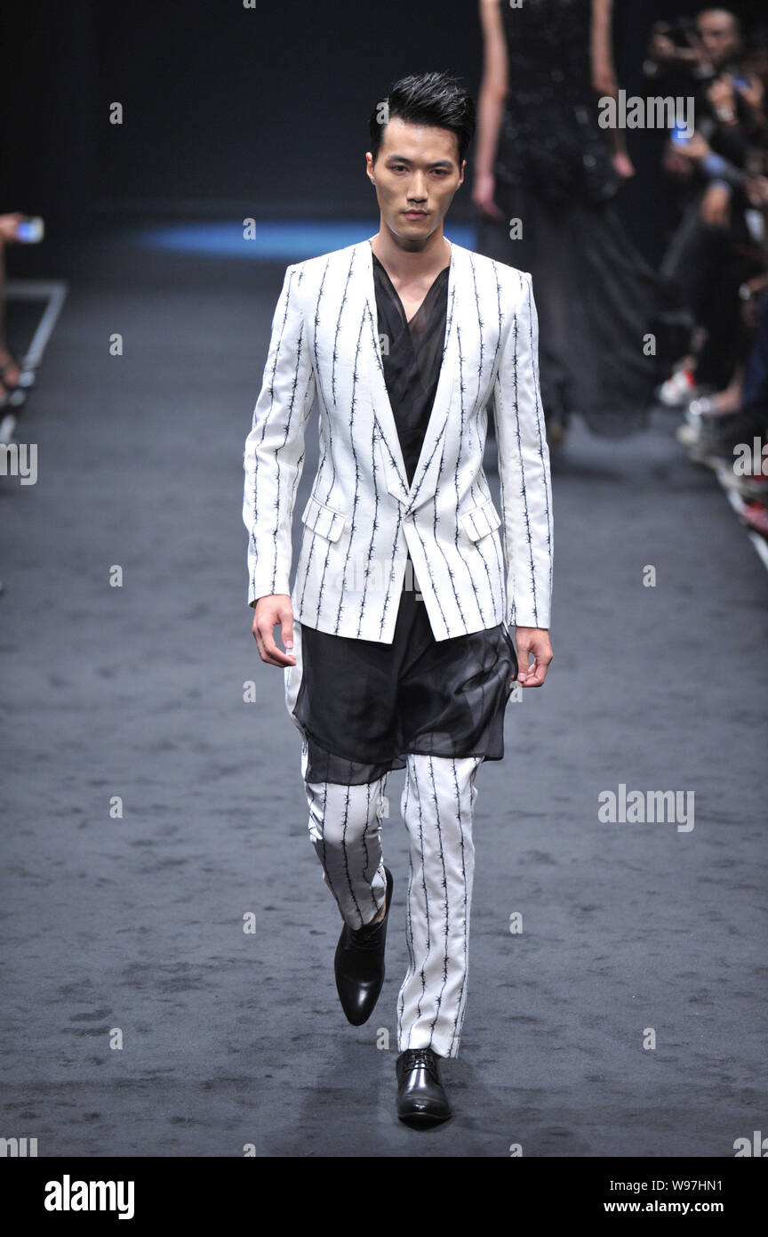 A model displays a new creation by designer Wang Peiyi in his fashion ...