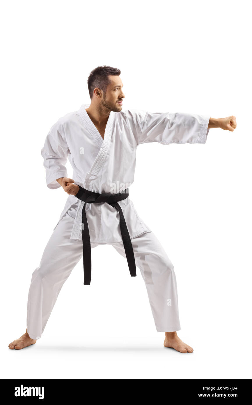 Full length shot of a young man in kimono exercising karate isolated on white background Stock Photo