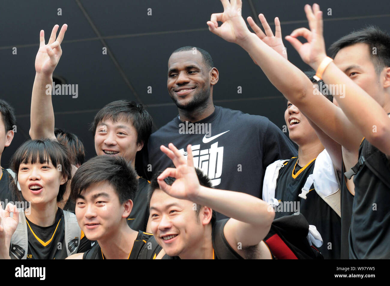 NBA star LeBron James poses with young basketball players in a visit to a  basketball training camp during his China tour in Shanghai, China, 18  August Stock Photo - Alamy