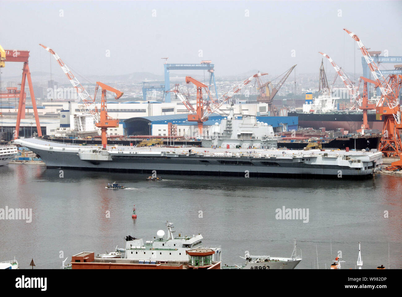 The aircraft carrier Varyag is pictured at a shipyard in Dalian city, northeast Chinas Liaoning province, 31 July 2011.   Chinas neighbours are worrie Stock Photo