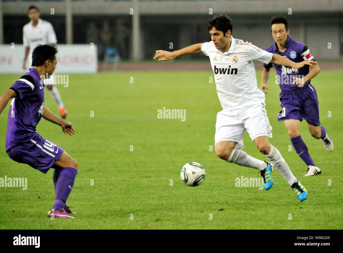 Ricardo Izecson dos Santos Leite, known as Kaka of Real Madrid, second right, challenges a football player of Tianjin Teda during a friendly soccer ma Stock Photo