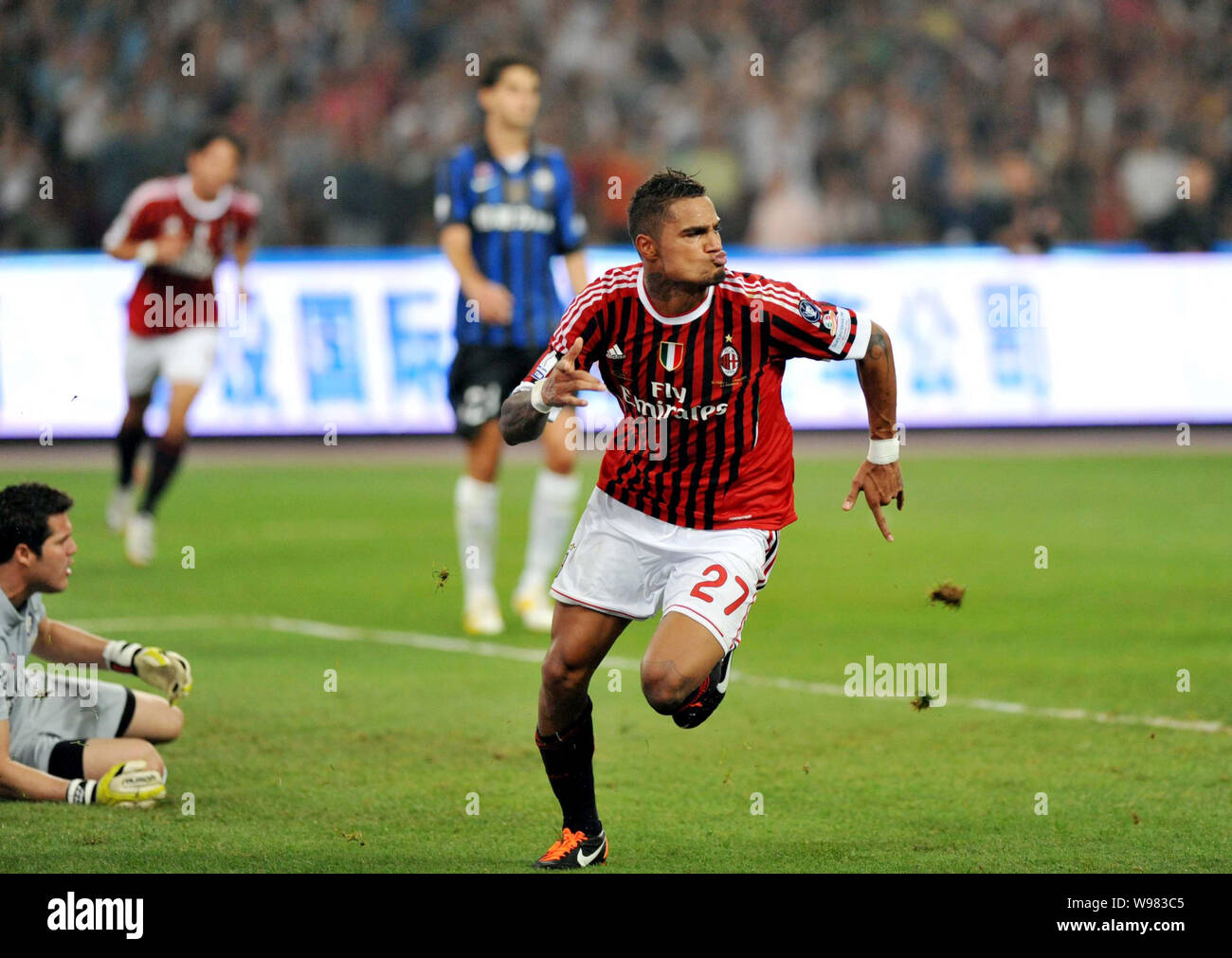 Kevin-Prince Boateng of AC Milan celebrates after scoring against Inter Milan during the Italian Super Cup 2011 match at the National Stadium, known a Stock Photo