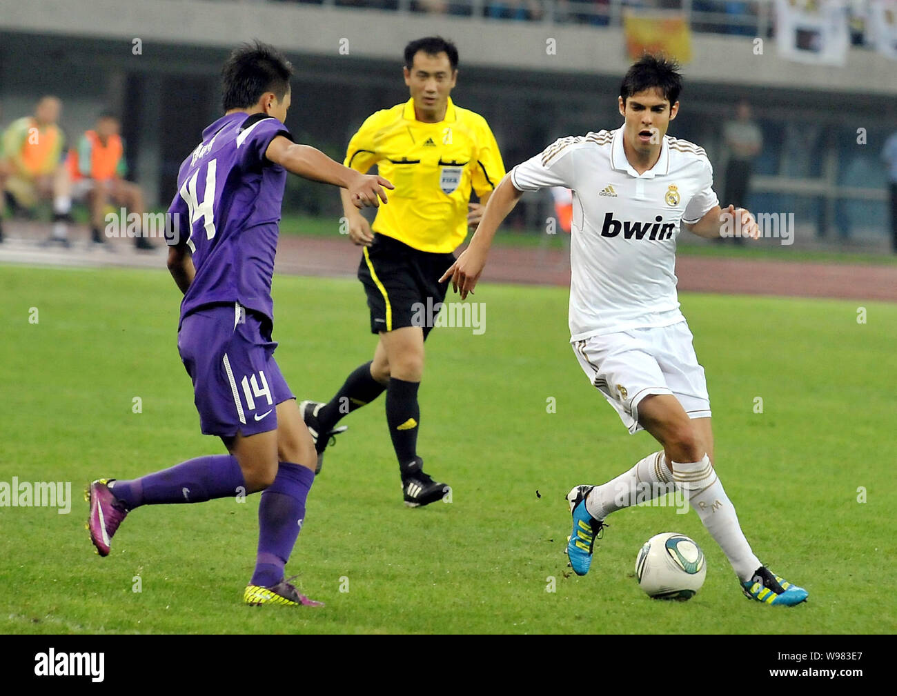 Ricardo Izecson dos Santos Leite, known as Kaka of Real Madrid, right, challenges a football player of Tianjin Teda during a friendly soccer match in Stock Photo